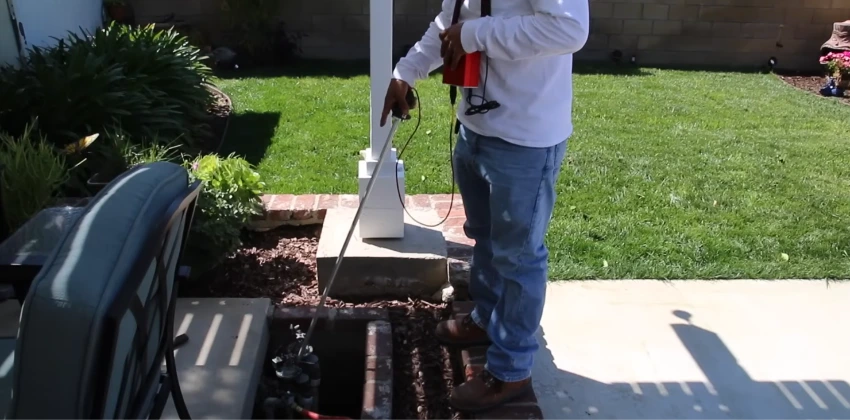 Technician testing an irrigation line for a hidden leak