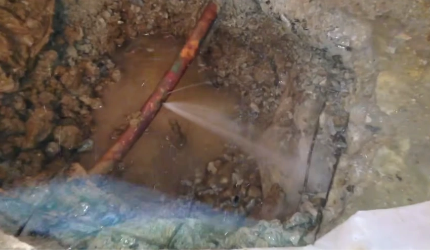 Technician using leak detection equipment during a plumbing inspection